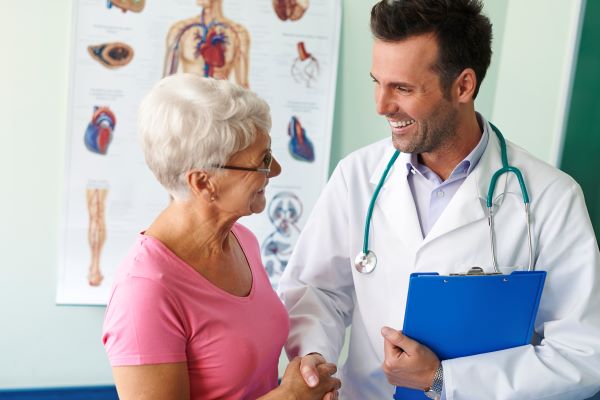 Senior woman talking with a smiling doctor