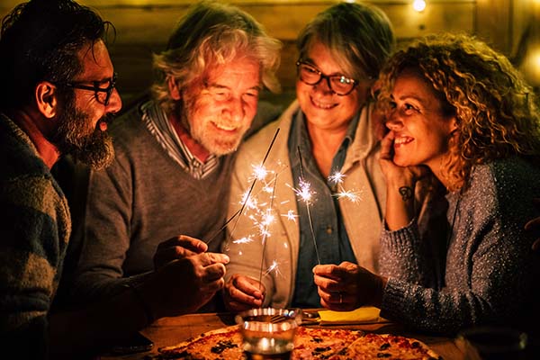 family gathering and lighting sparklers for new years 2022