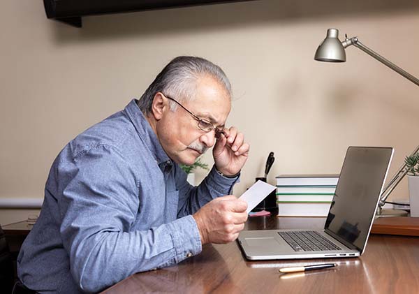 elderly man reviewing his free, No-obligation Home Survey for a Chair Lift